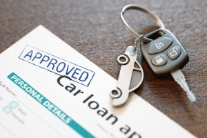 Approved car loan application form and car keys