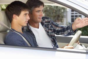 Car Loans Banner - Father teaching his son to drive