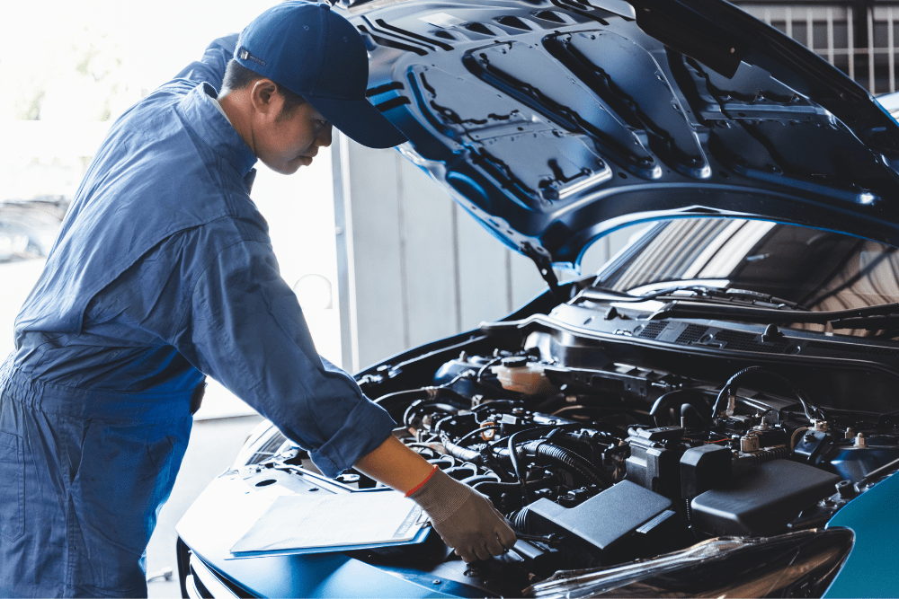 Car Loans Banner - Mechanic inspecting under the bonnet of a car