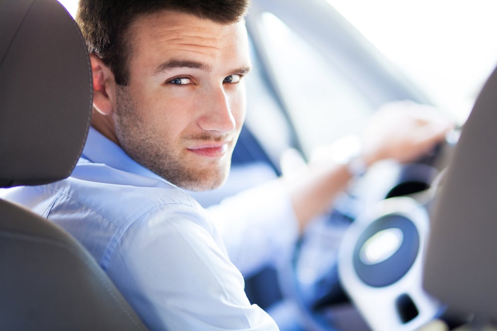 Man driving his car for work