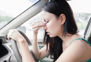 Woman feeling motion sick in car