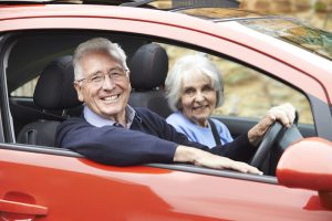 Senior couple out for drive in car