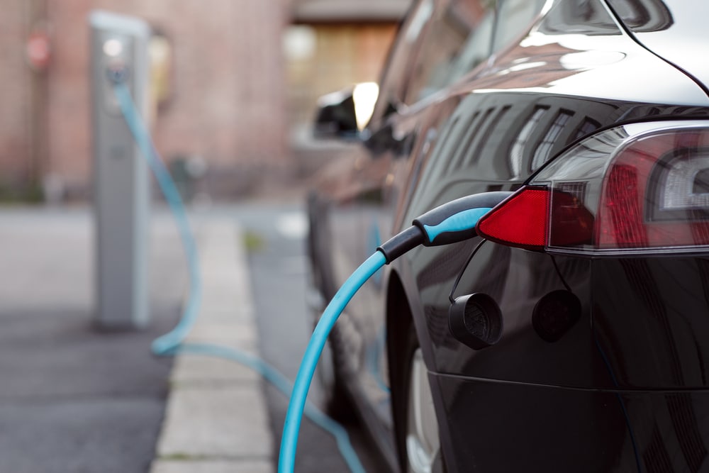 Car plugged into electric charging point