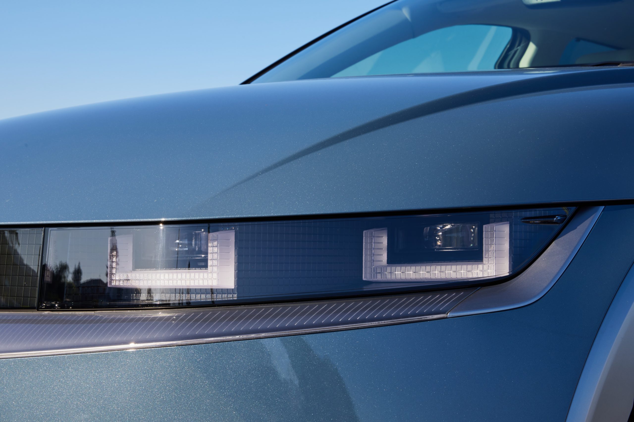Hyundai IONIQ 5 light blue close up of rectangular LED headlights