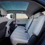 Hyundai IONIQ 5 inside cabin view looking across rear passenger and driver's white leather seats from door