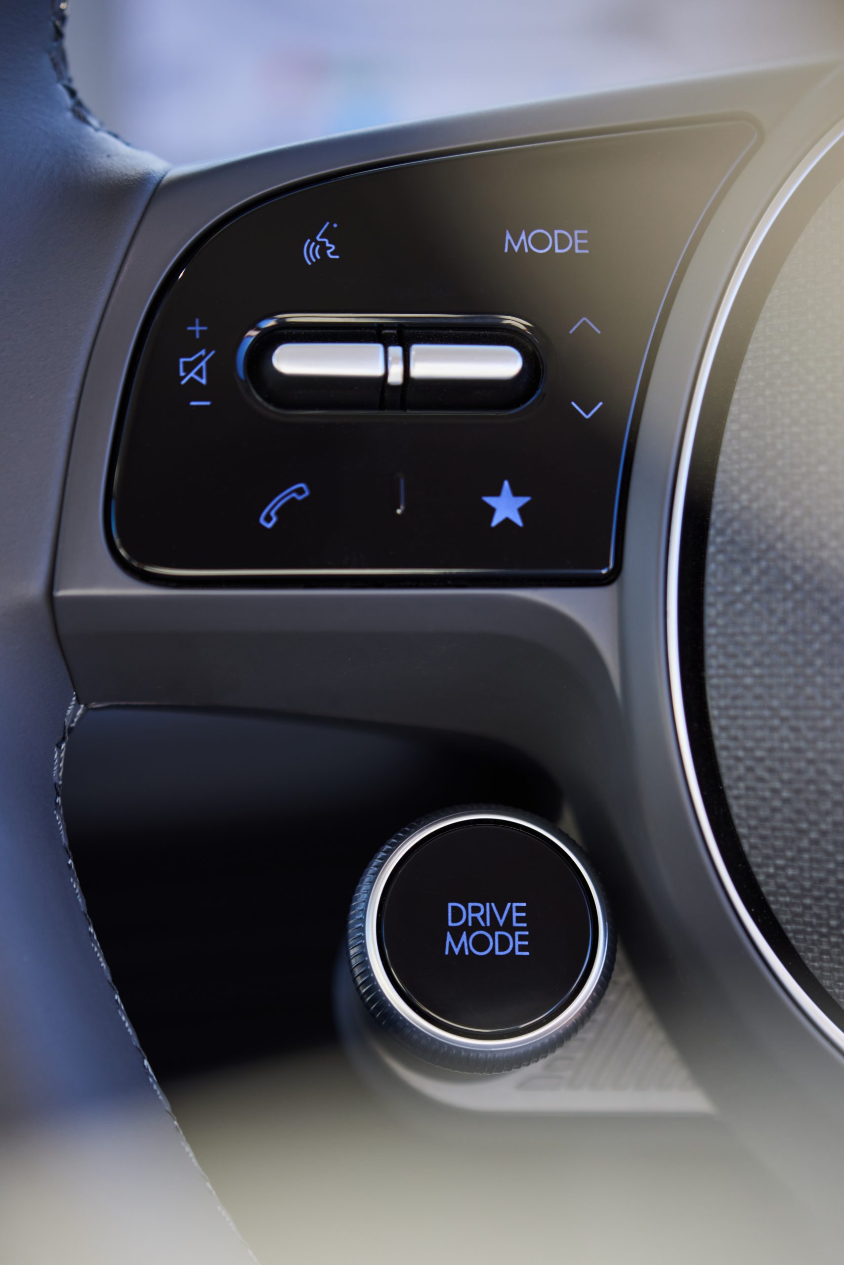 Interior of Hyundai IONIQ 5, close-up of dash phone speaker and drive mode buttons