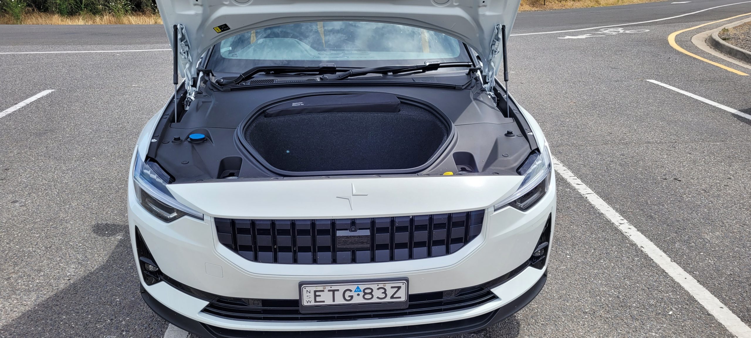 Polestar 2 EV with front hood open showing the frunk