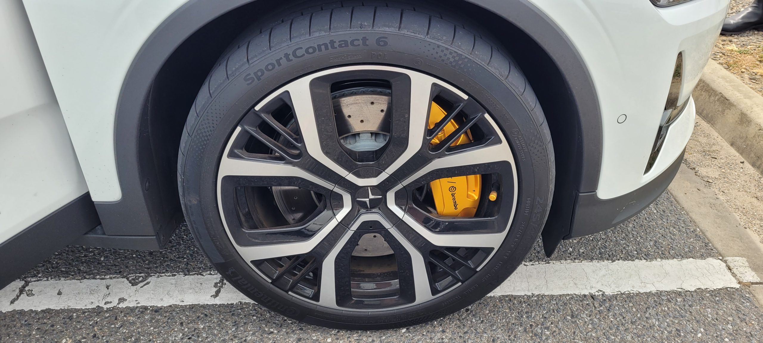 Polestar 2 20 inch rim close up of tyre and gold Brembo brakes