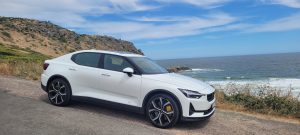 White Polestar 2 parked by the sea
