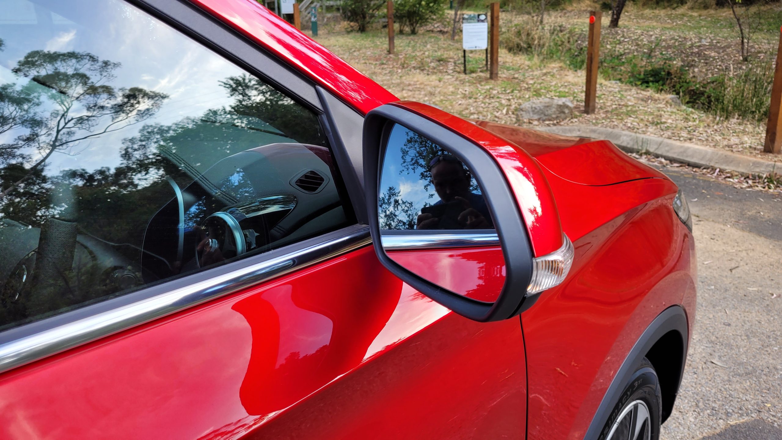 Red MG ZS EV driver side mirror