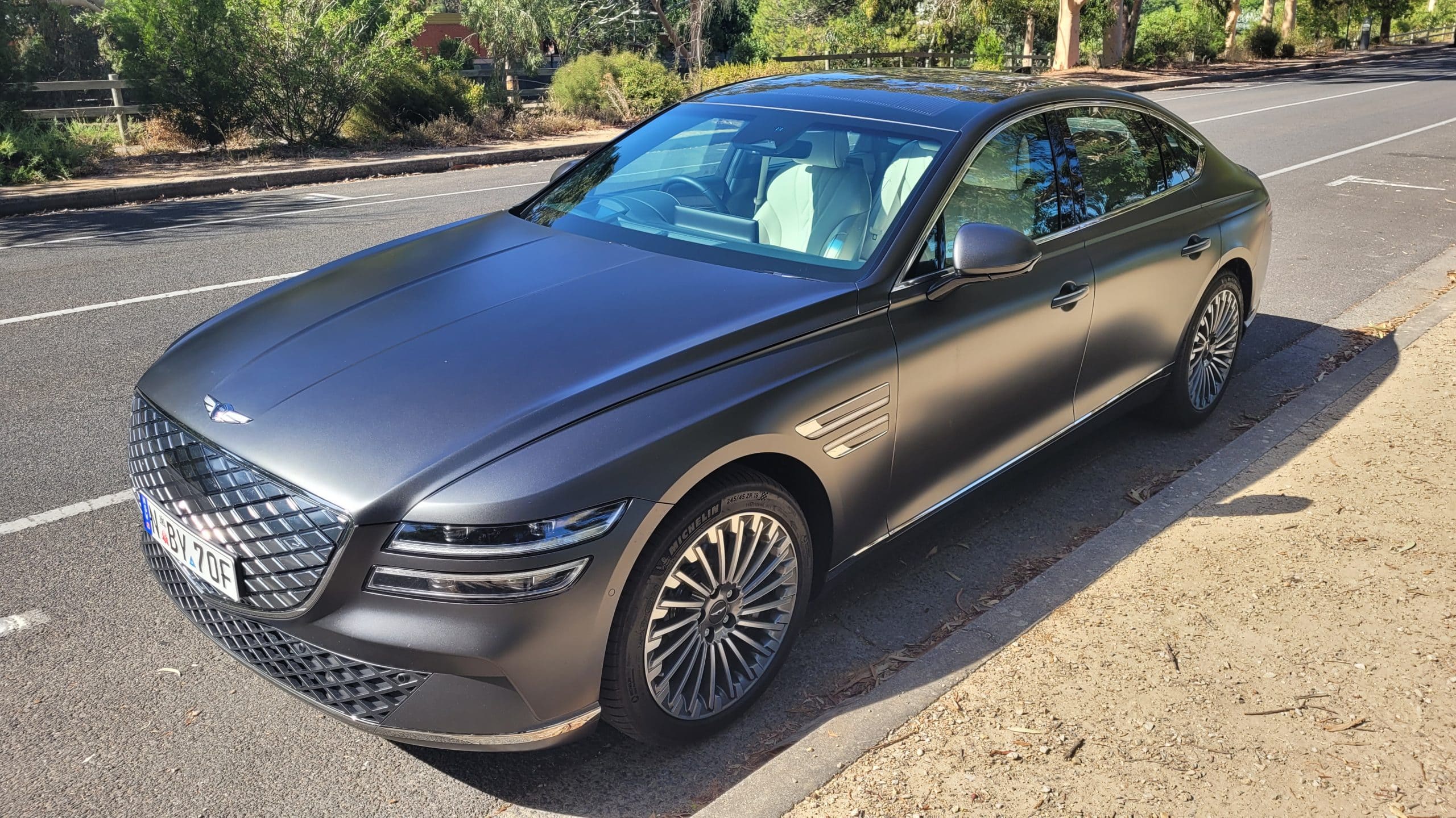 Makalu Matte Gray Genesis G80 electric front angle view on street