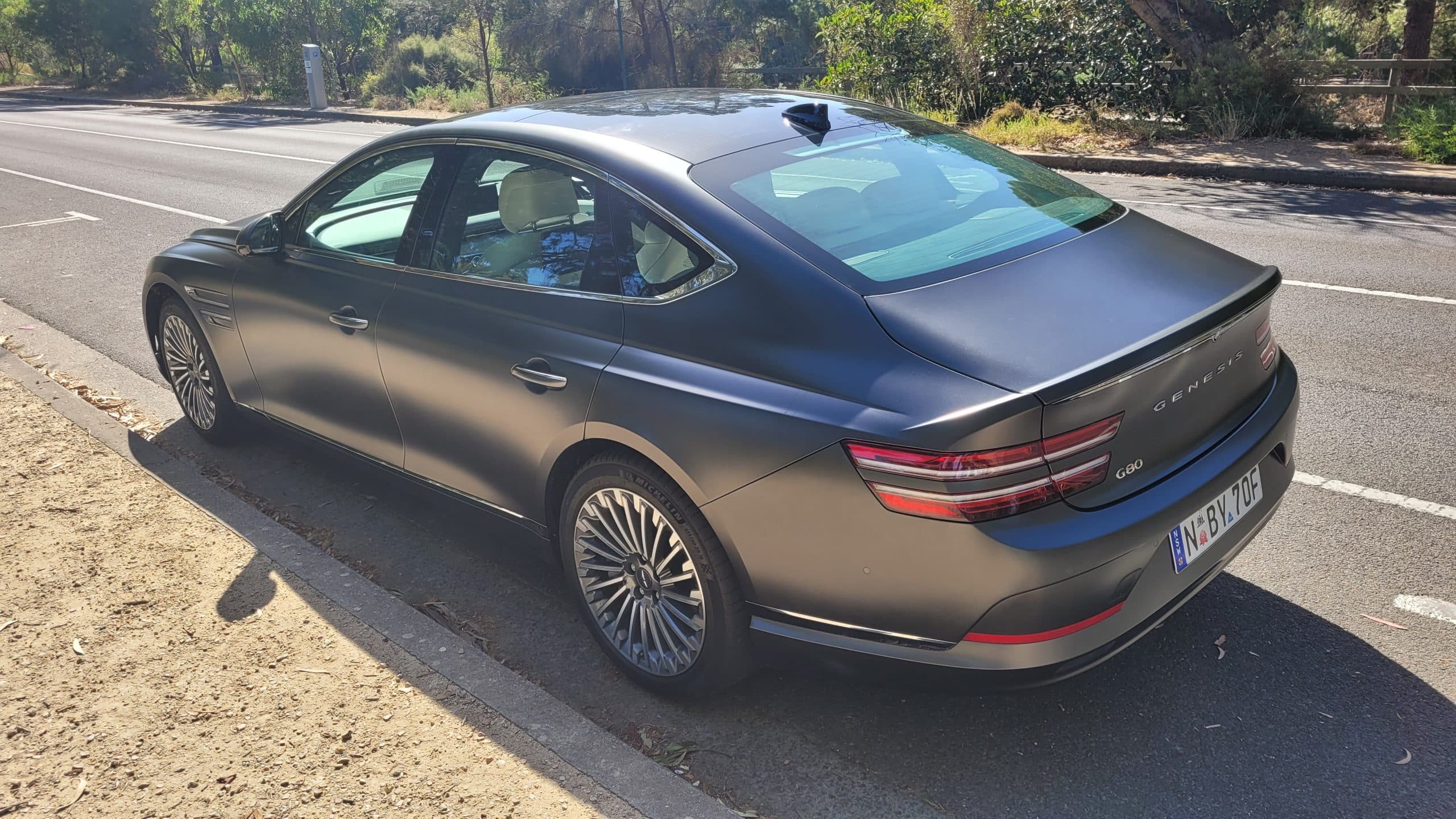 Makalu Matte Gray Genesis G80 electric rear left quarter panel view