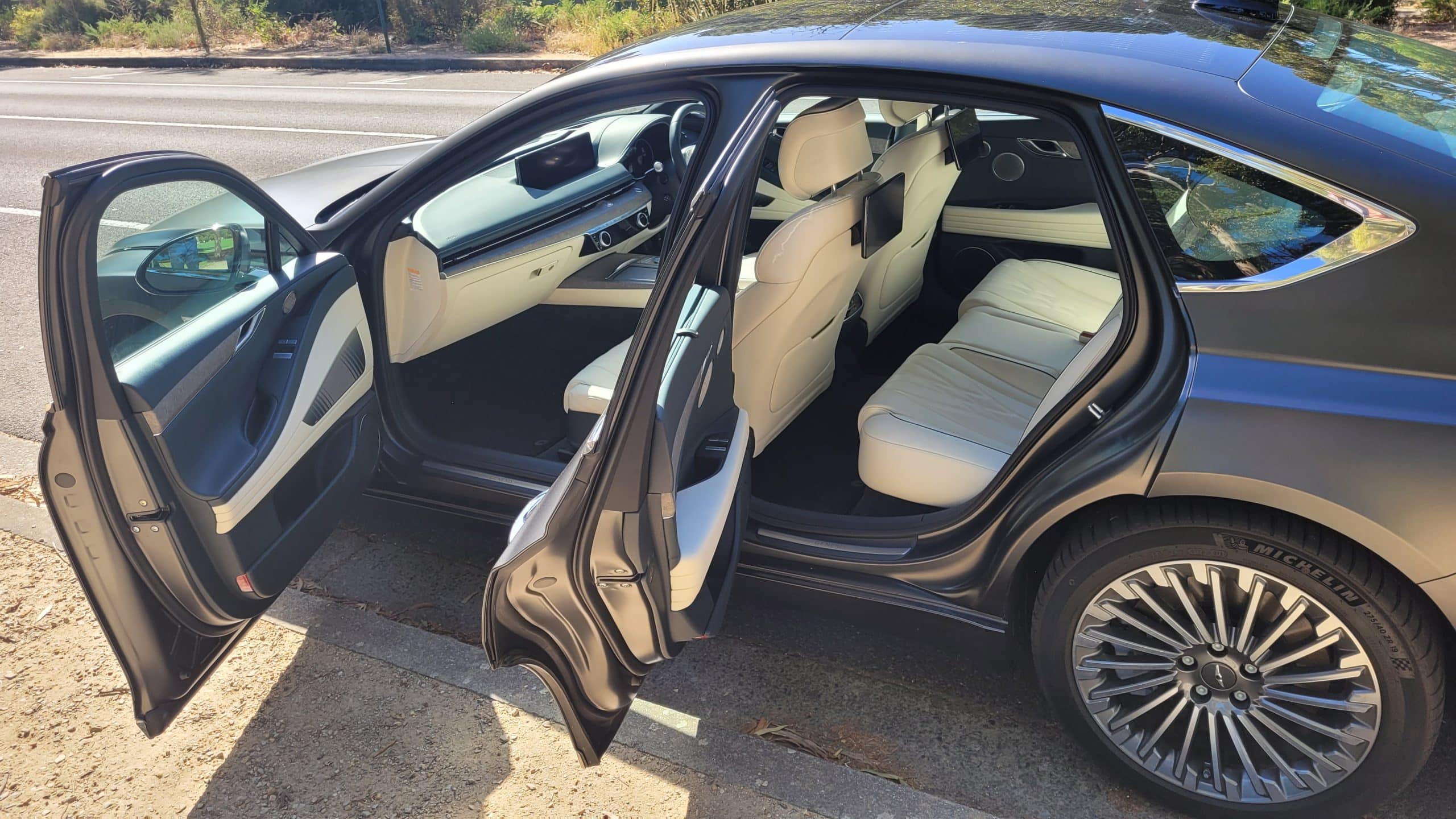 Makalu Matte Gray Genesis G80 electric vehicle with passenger doors open