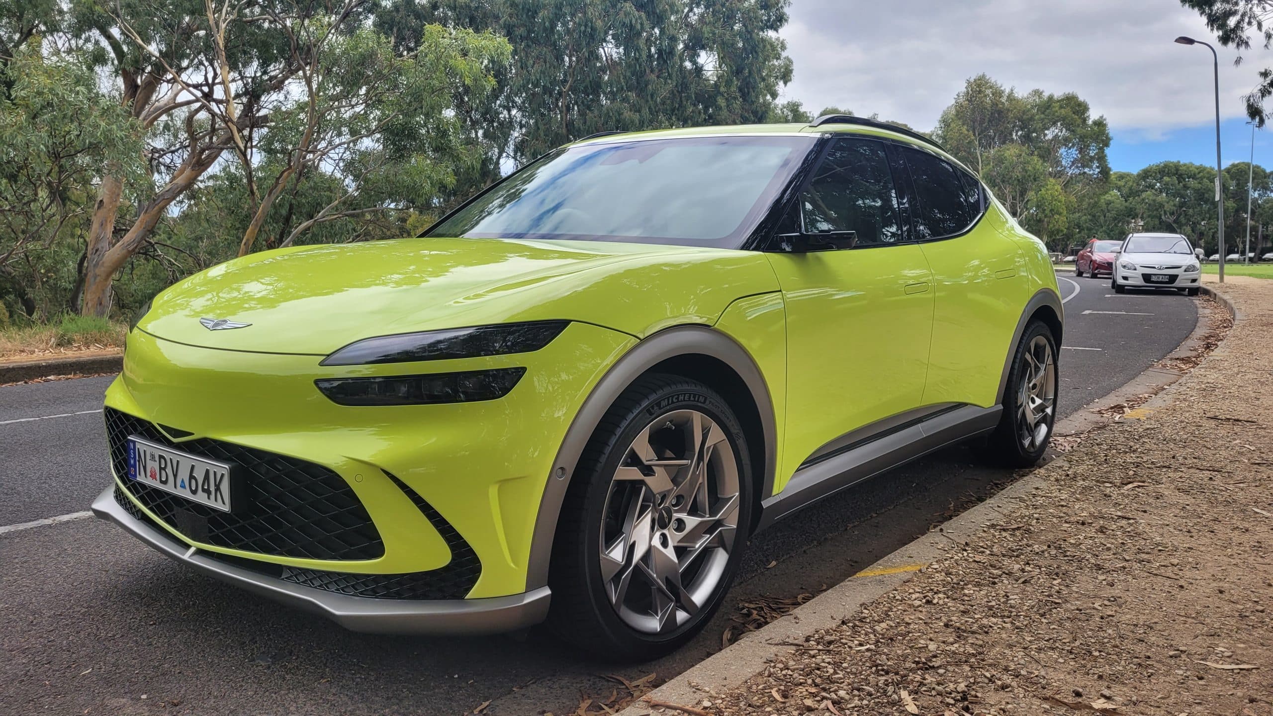 Genesis GV60 lime green front low view of wheel and front fender