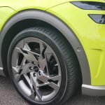 Genesis GV60 lime green view of front right-hand mag wheel.
