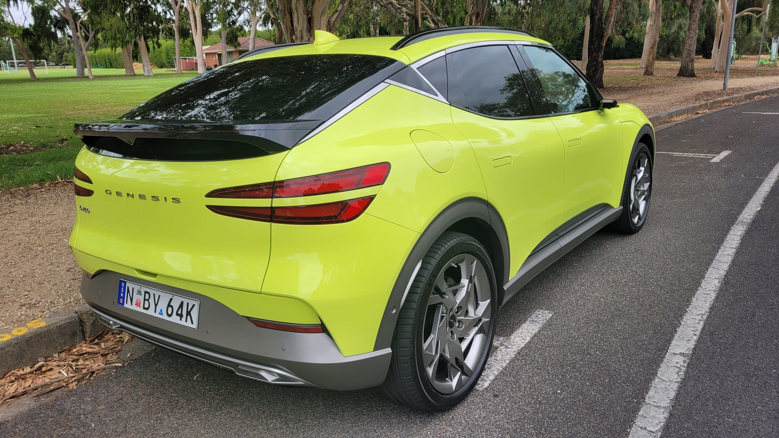 Sao Paulo Lime green Genesis GV60 rear corner view with sleek tail lights