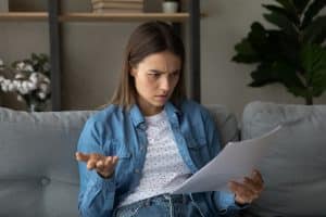 Young woman stressed over her rental contract