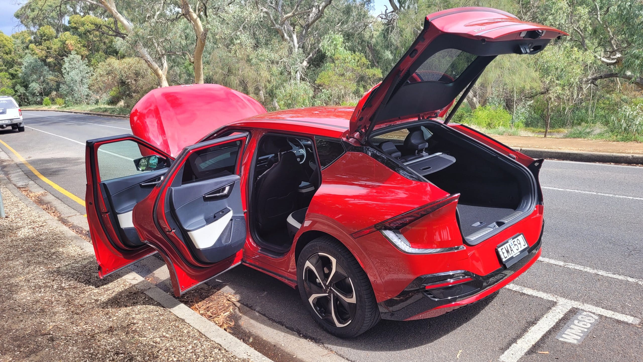 Red Kia EV6 GT-Line exterior rear corner veiw with doors open