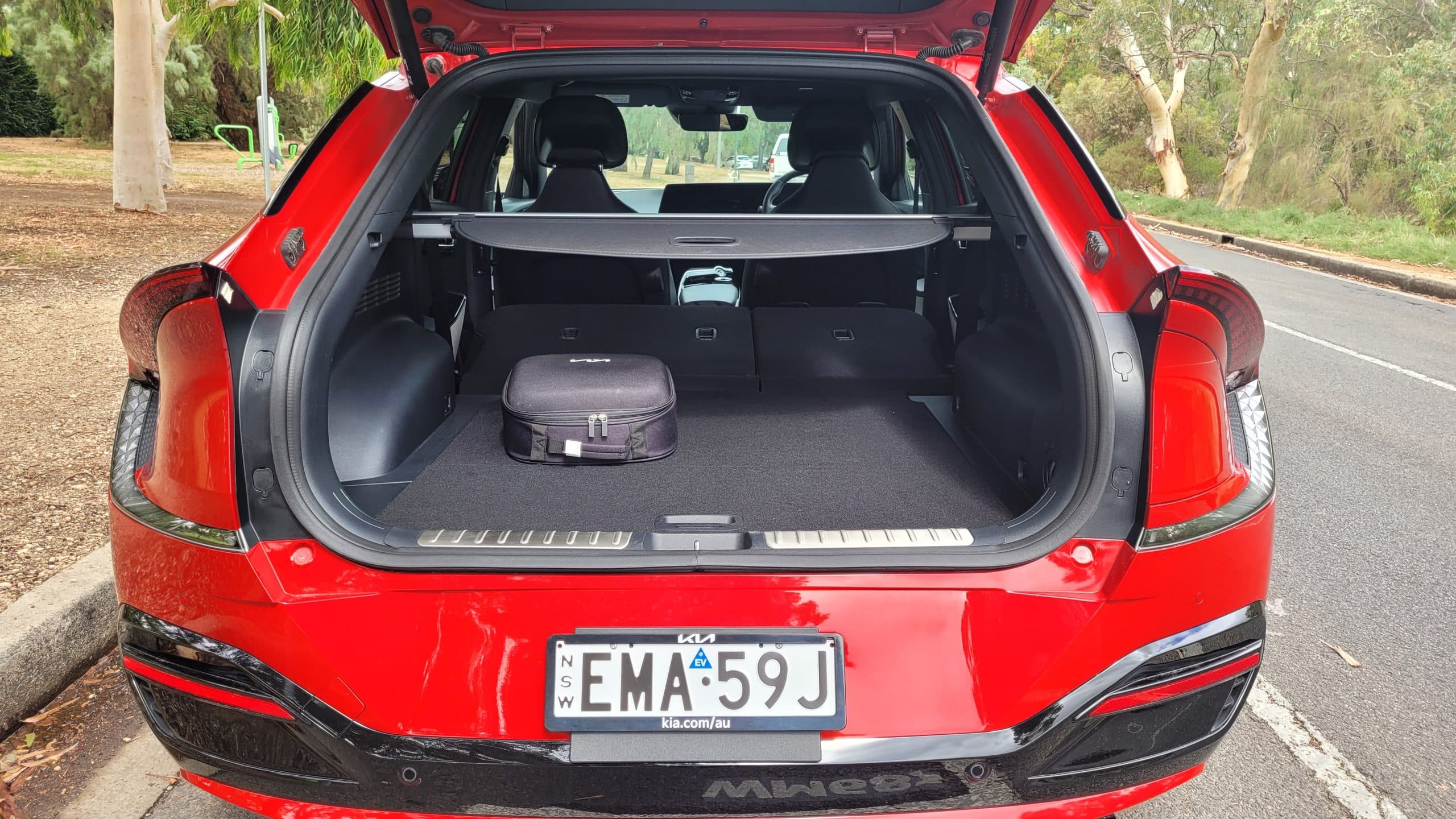 Red Kia EV6 GT-Line exterior rear view with boot open