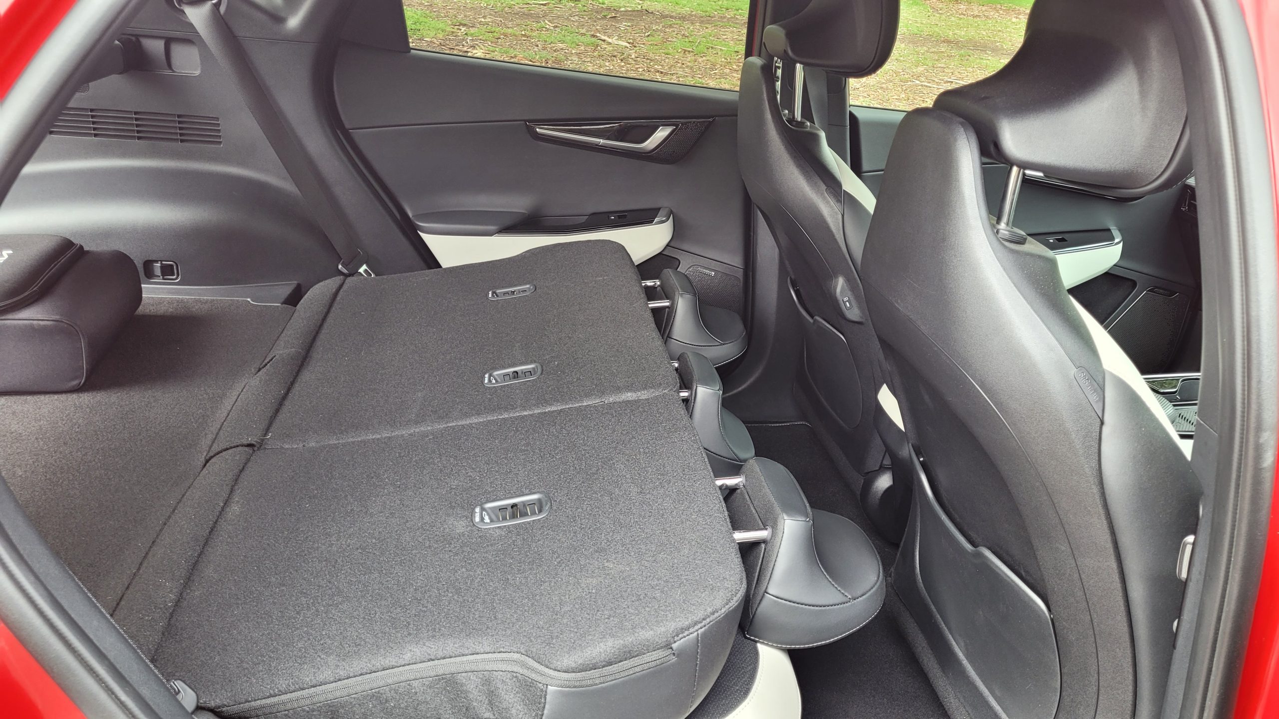 Red Kia EV6 GT-Line back seat view with rear seats folded down