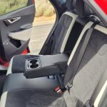 Red Kia EV6 GT-Line rear seat interior view with middle arm rest and cup holders in down position