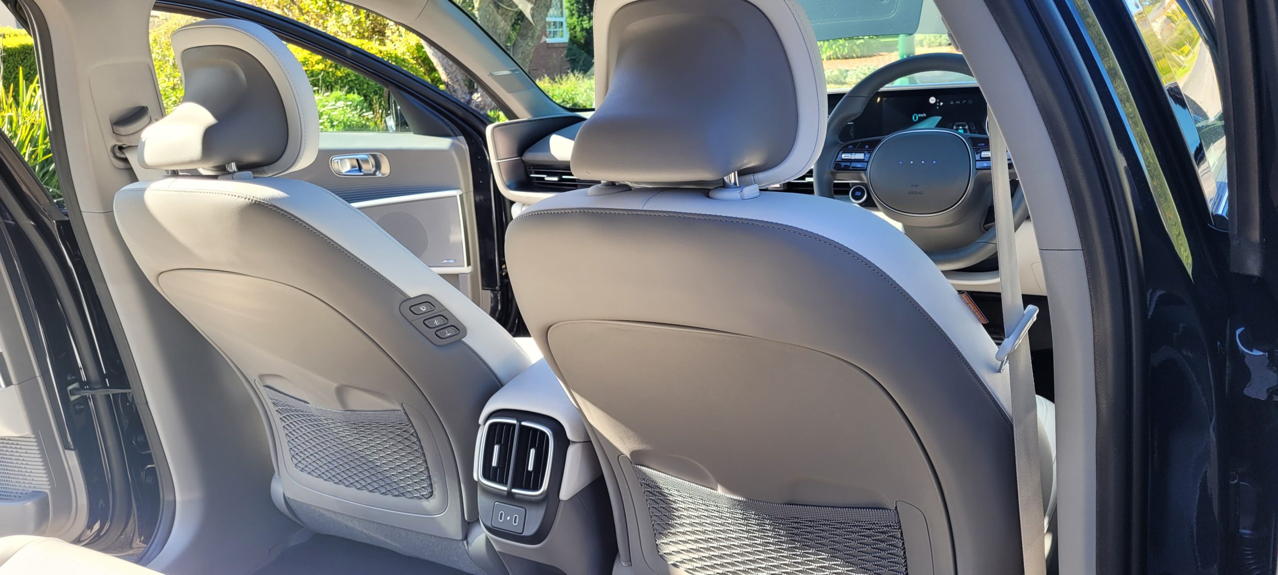 Black Hyundai IONIQ 6 interior view of front seats from back
