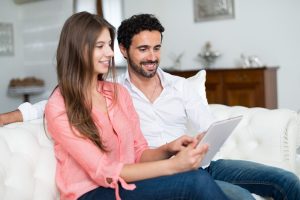 Life Insurance Banner - Young couple choosing their life insurance policy on a tablet