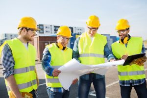 Business Loans Banner - Group of construction workers looking at building plans