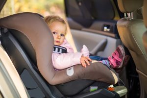 Car Loans Banner - Baby facing forward in a child's car seat
