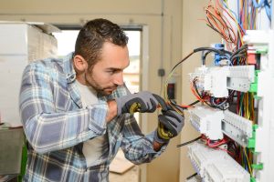 Business Loans Banner - Electrician fixing wiring in a house