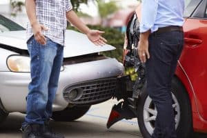 Car Insurance Banner - Two men disputing fault after a car accident