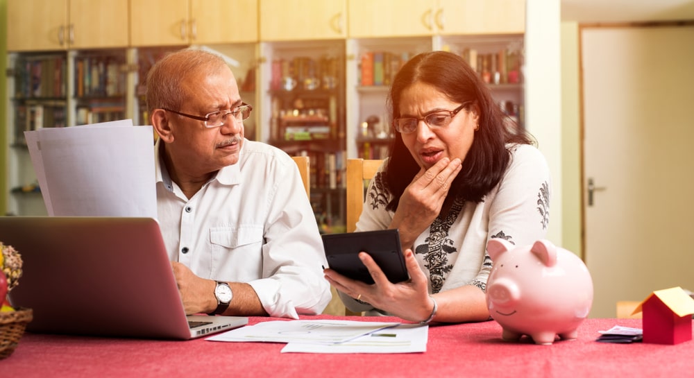 Personal Loans Banner - Middle-aged couple looking at documents before applying for a non-conforming loan