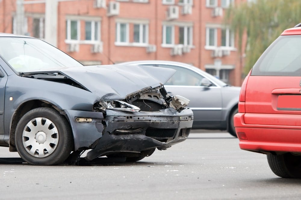 Car Insurance Banner - A crashed car on the road after an accident