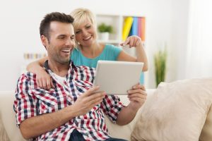 Small Loans Banner - Couple looking at quick cash loans on their tablet together