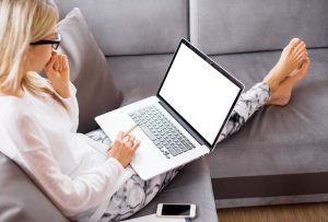 Internet Banner - Woman sitting on the couch on her laptop