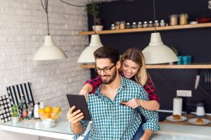 Internet Banner: Person sitting on a person's back while holding a tablet