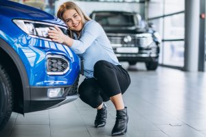 Young woman celebrating buying a new car