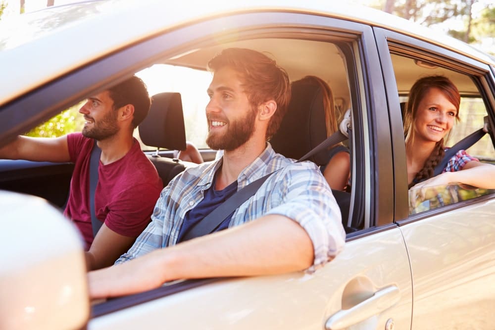 Car Loans Banner - Group of friends driving around in a car.