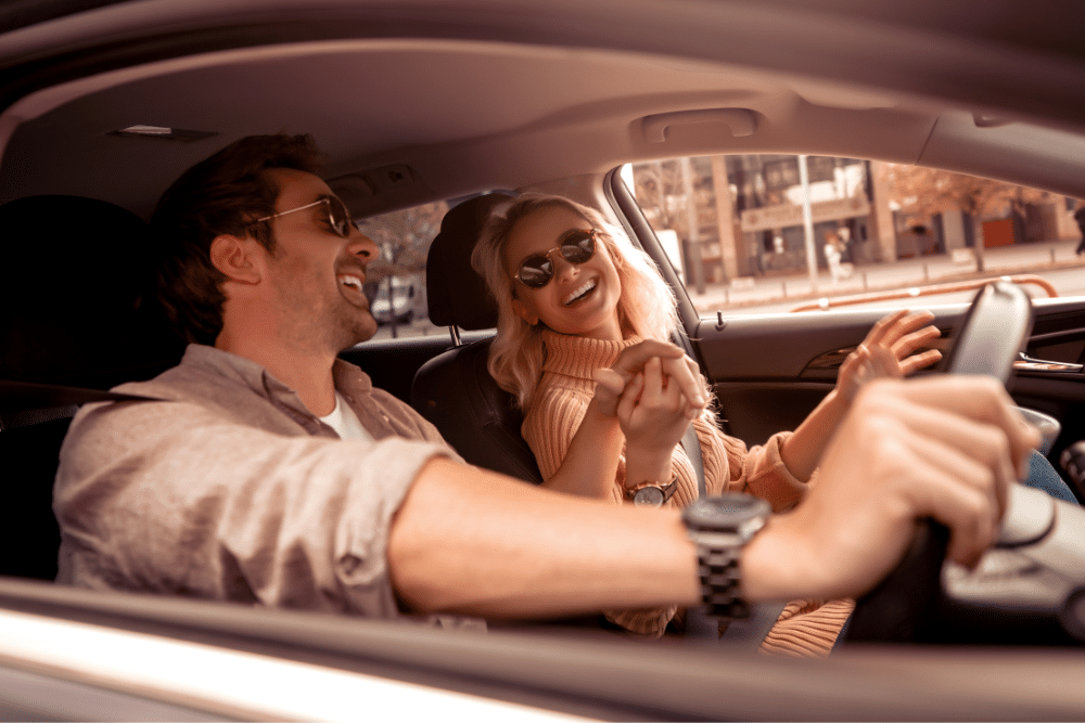 A couple driving car on their holiday