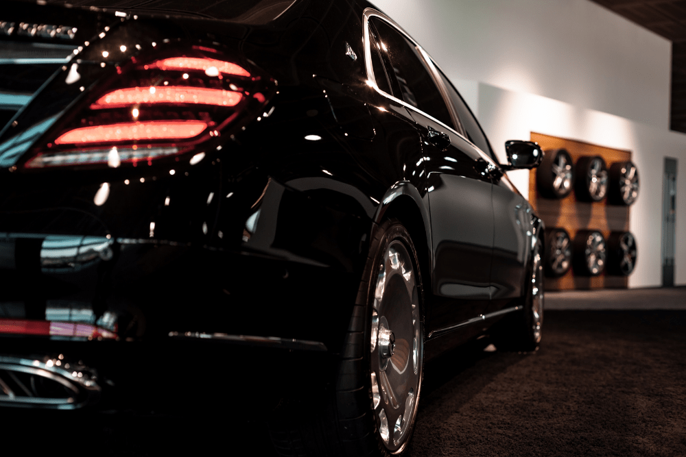 Car Loans Banner - Luxury black car in a showroom