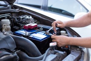 Car battery being installed in car