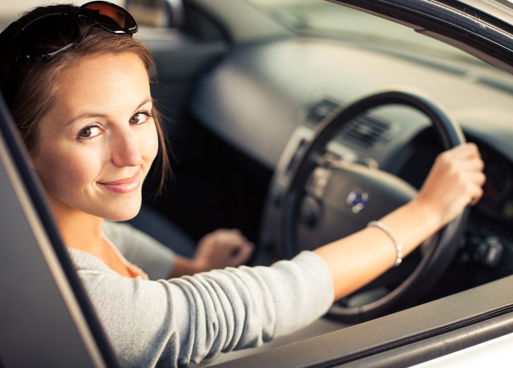 Woman behind wheel of car