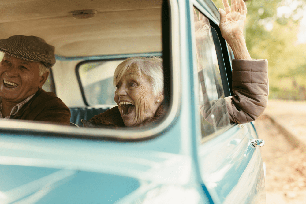 Car Loans Banner - Senior pensioner couple driving in a car together